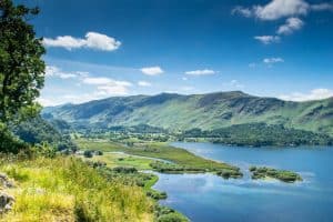 Scenic view of Lake District: hills in the back, lake in front and lots of green areas