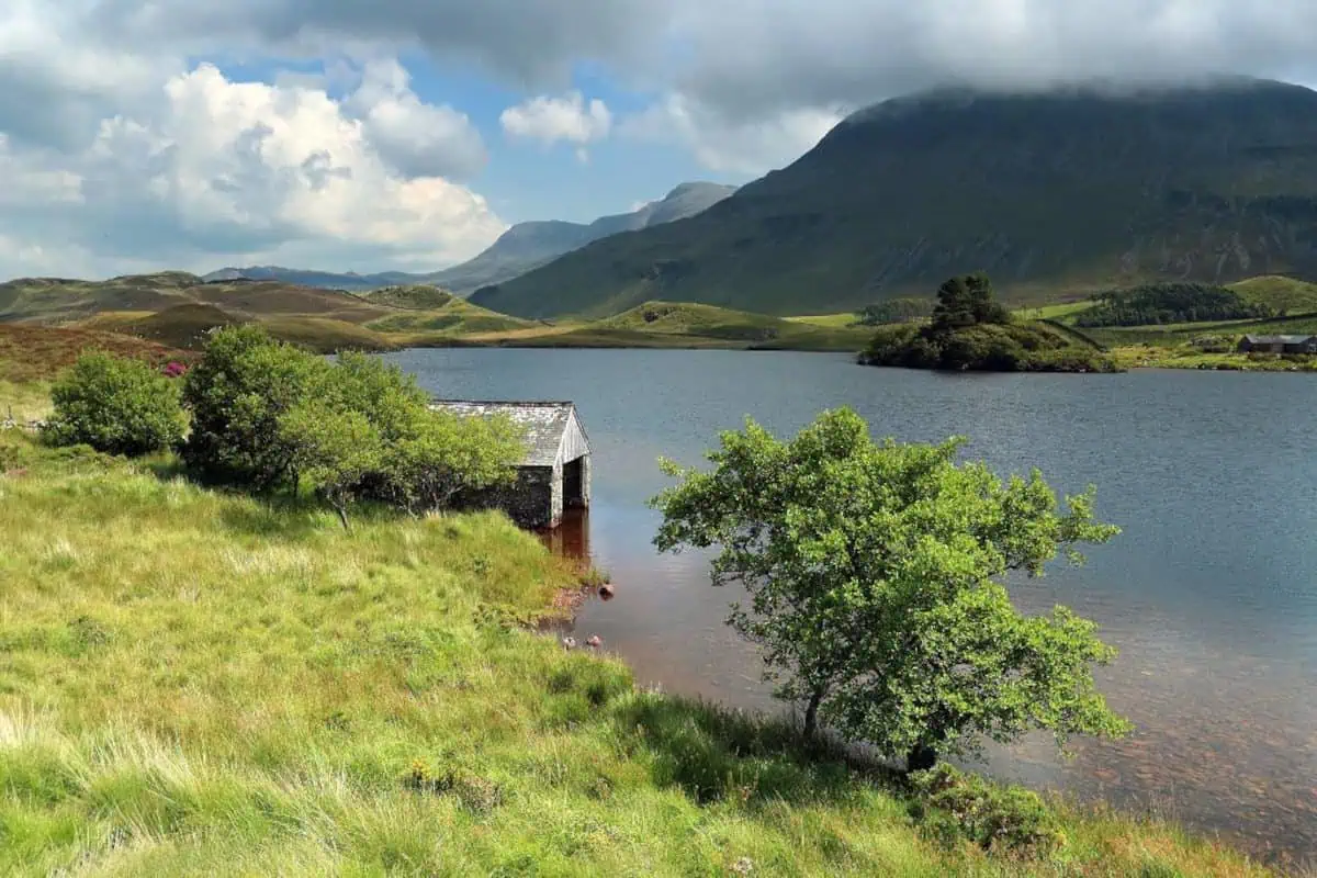 Scenic photo of Snowdonia National Park - hills, water and grass