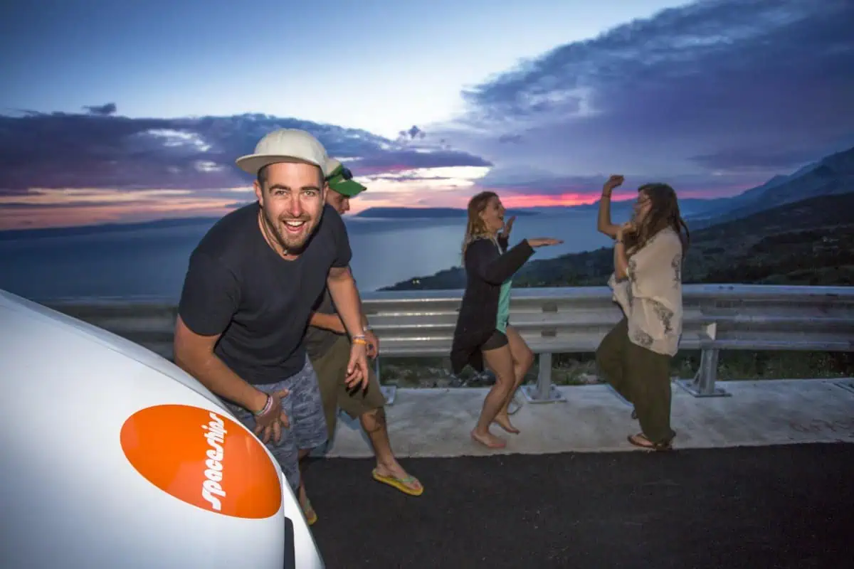 Travellers enjoying sunset on their Euro road trip